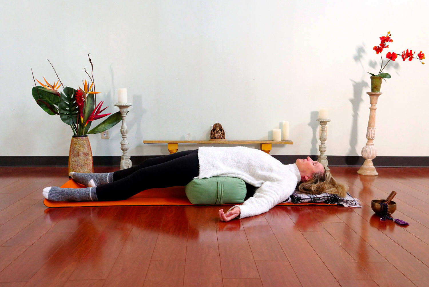 All That Matters yogi Michelle Tremont relaxes into a restorative yoga pose, which preps mind and body for sleep