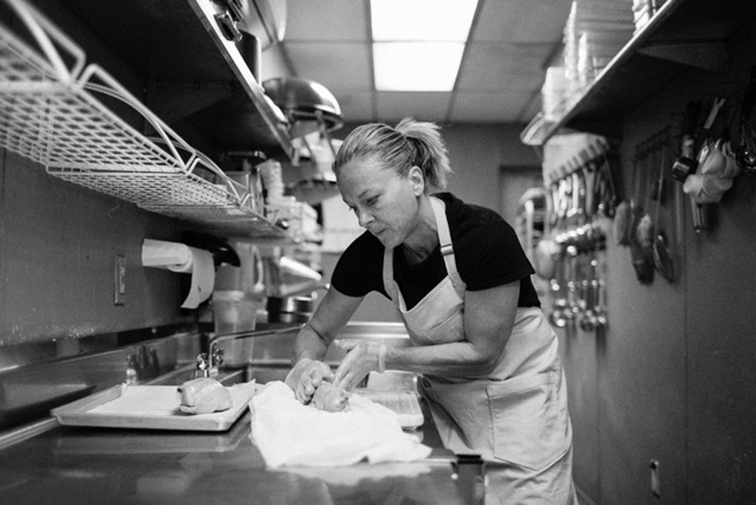 Chef Jeanie Roland rolls foie gras torchon at Ella’s Food and Drink