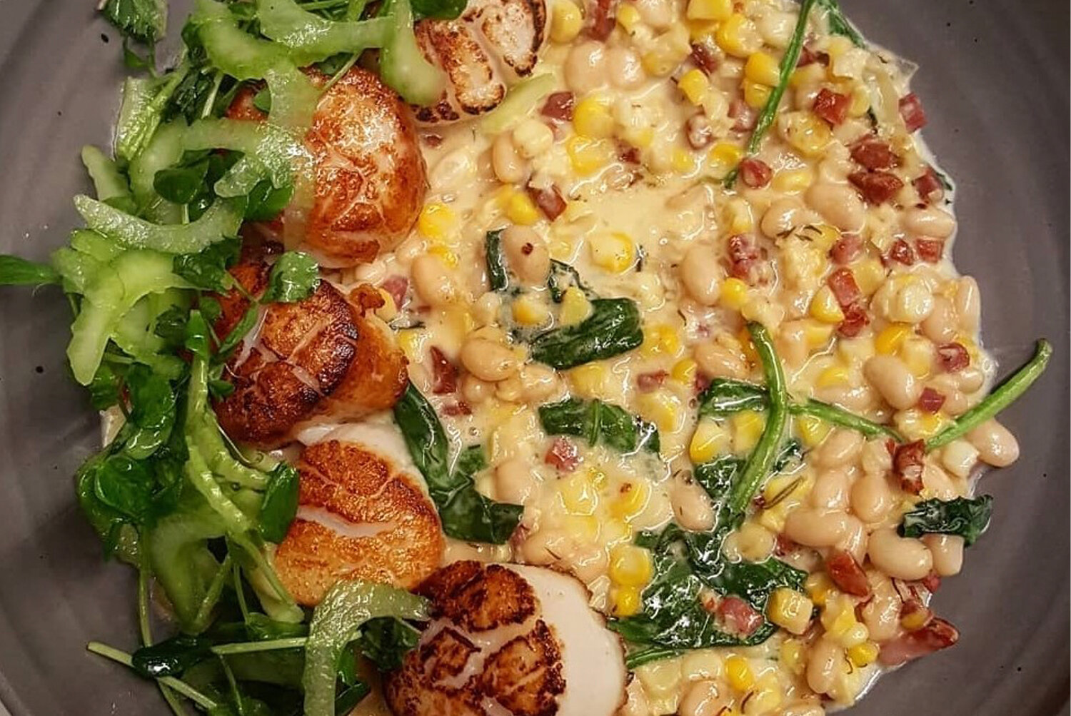 Pan-seared scallops in sweet corn chowder is among summer fare at The Tavern
