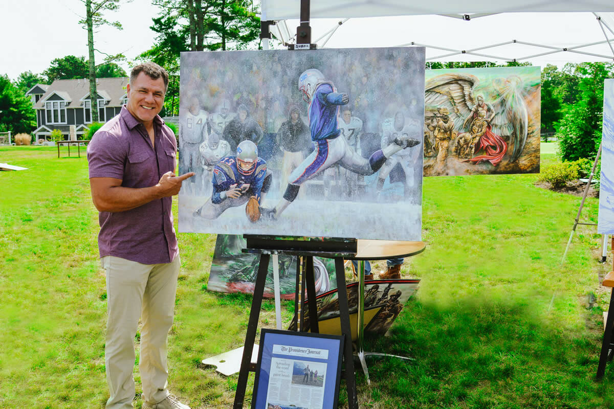 Adam Vinatieri captured with Clays 4 Charity artist’s painting of his tie-winning kick in the 2001 New England Patriots VS Oakland Raiders game